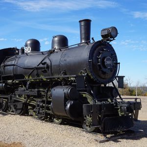 Black train locomotive with stairs leading up to the front