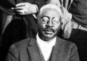 African American man in glasses and suit