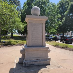 Concrete sculpture with sphere on top with "1812" engraved on it