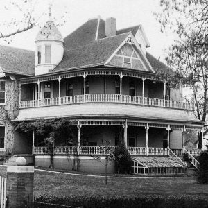 Multistory wooden white house with porch