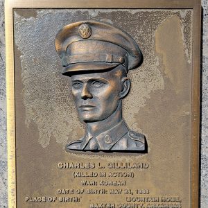 Man's face on bronze plaque