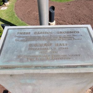 Plaque atop concrete block with dedication to Secretary of State C. G. "Crip" Hall