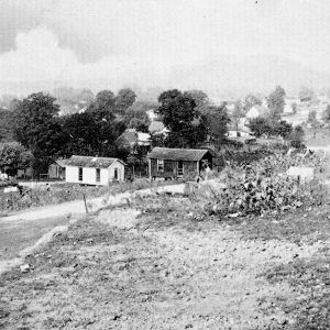 Looking at small town houses from atop a hill