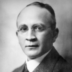 White man in suit and tie and glasses