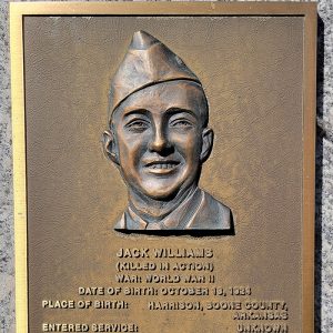 Man's face on bronze plaque