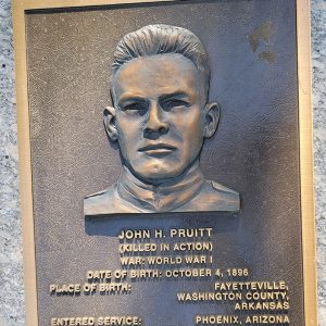 Man's face on bronze plaque