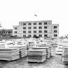 Large stacks of white marble squares sitting in front of white marble building