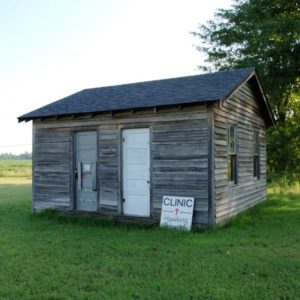 Single story wooden house with sign saying "Clinic Hawkins"