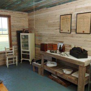 Interior room of wooden building with medical implements on table