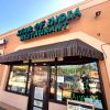 Beige storefront restaurant with sign saying "Star of India Restaurant" in green letters