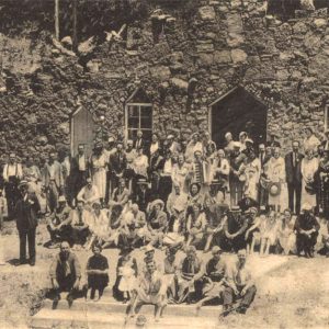 Large crowd of people in front of rock building