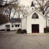 Multistory white church building with small tower