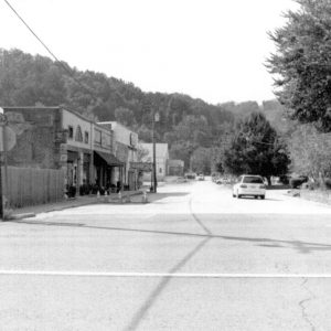 storefront buildings and cars on a street