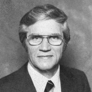 White man in suit and tie and glasses