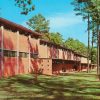 Blocky red brick buildings on wooded lot