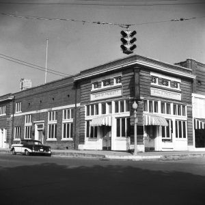 Multistory brick building with sign saying "Bank of Prescott"