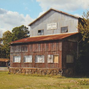 Multistory wooden and metal building with stone foundation