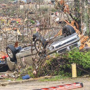 Scene of debris with vehicle upside down