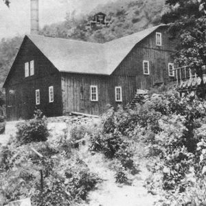 Multistory wooden building on the side of a hill