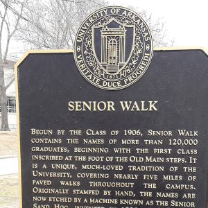 Metal plaque on pole "Senior Walk"