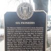 Metal sign on pole "Six Pioneers"