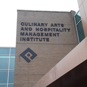 Glass and brick building exterior "Culinary Arts and Hospitality Management Institute"