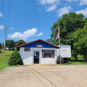 Single story white concrete block building