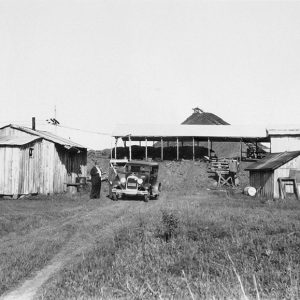 Series of buildings on a hillside with people and cars between them