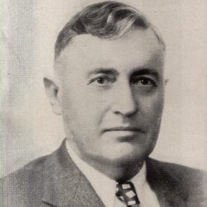 White man in suit jacket and tie