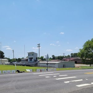 School buildings and sports track with bleachers and lights