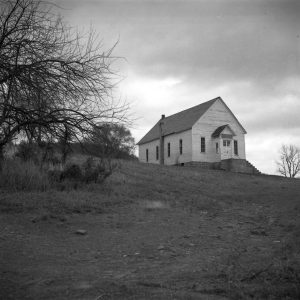 Wooden church building standing on top of hill