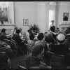 Large group of white women sitting in rows of chairs