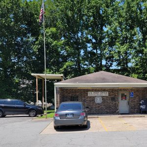 Single story brick building with parking lot