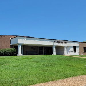 one story building round on one side and with white columns in front