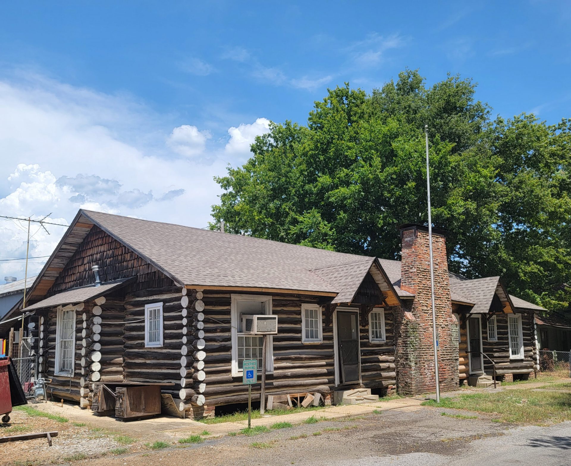 Single story log cabin with rock fireplace/chimney