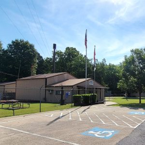 Multistory brown metal building "Garner City Hall" with parking lot