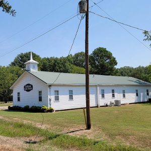 White wooden church building with cupola