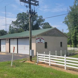 Tan concrete block building with white bays