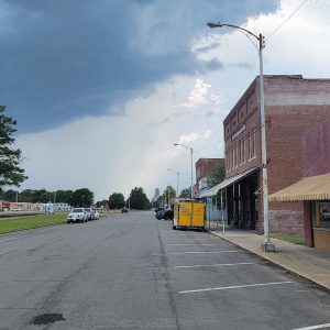 Small town street with buildings and parking spaces on the right