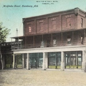 Multistory red and white brick building with covered porches