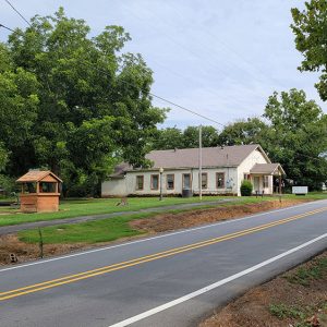 Various buildings including a white church along highway