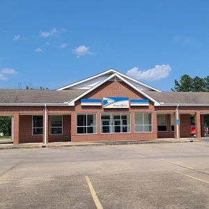 Single story red brick building with a parking lot