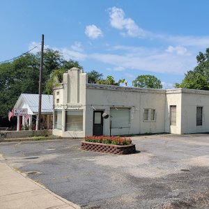 Single story tan block building with large windows