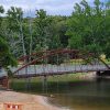 arched red bridge over water