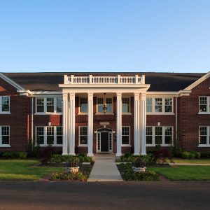 Multistory red brick building with white columns