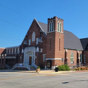 Multistory red brick church building on street corner