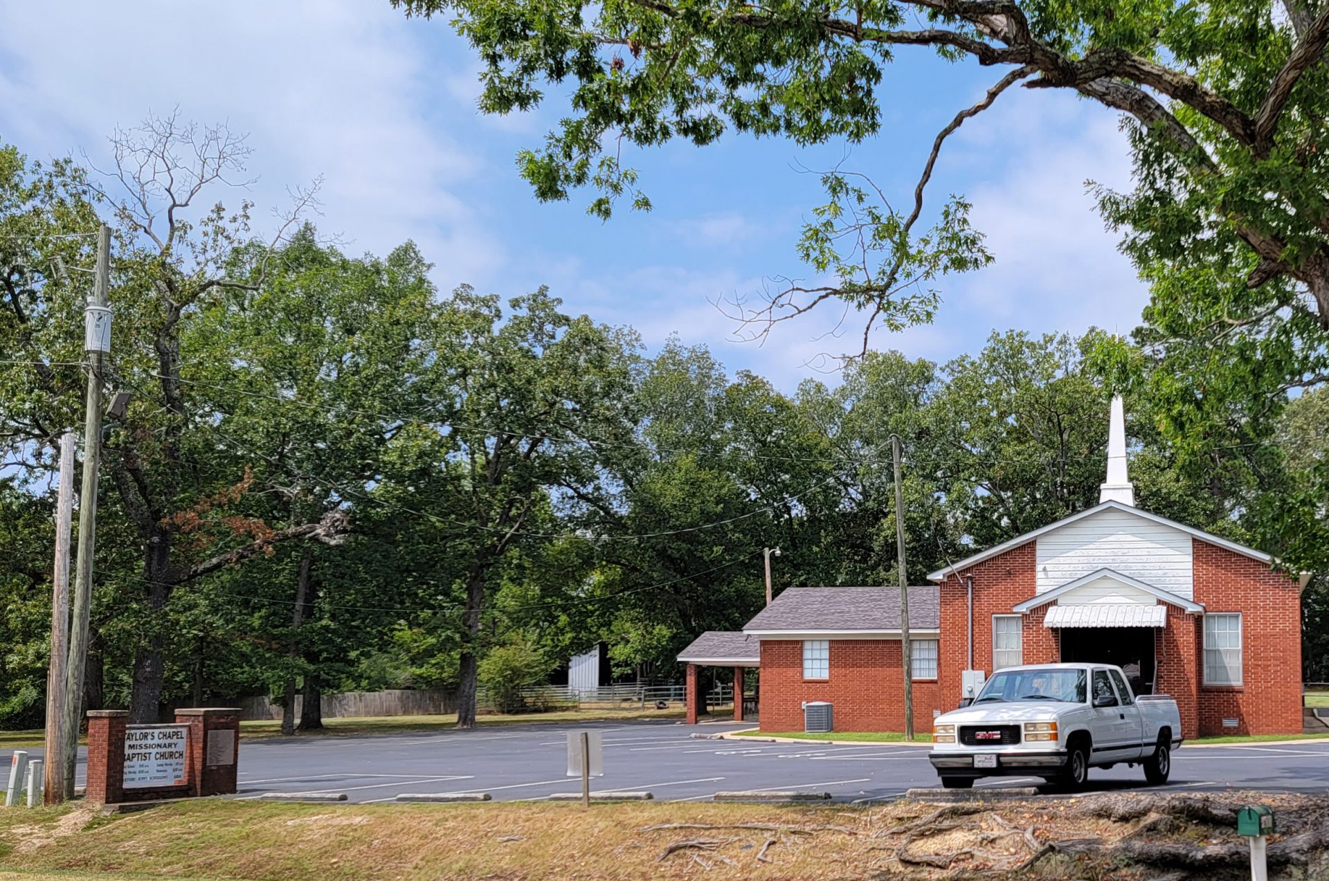 Red brick church building with steeple