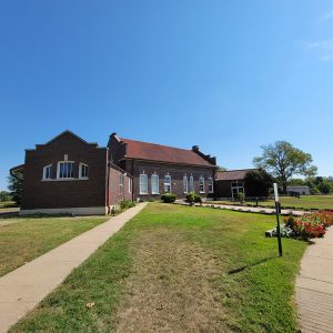 Multistory brown brick building with red tile roof