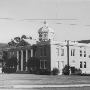 Multistory granite building with cupola and doric columns