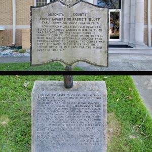 Two signs with words about the history of the Ouachita County Courthouse